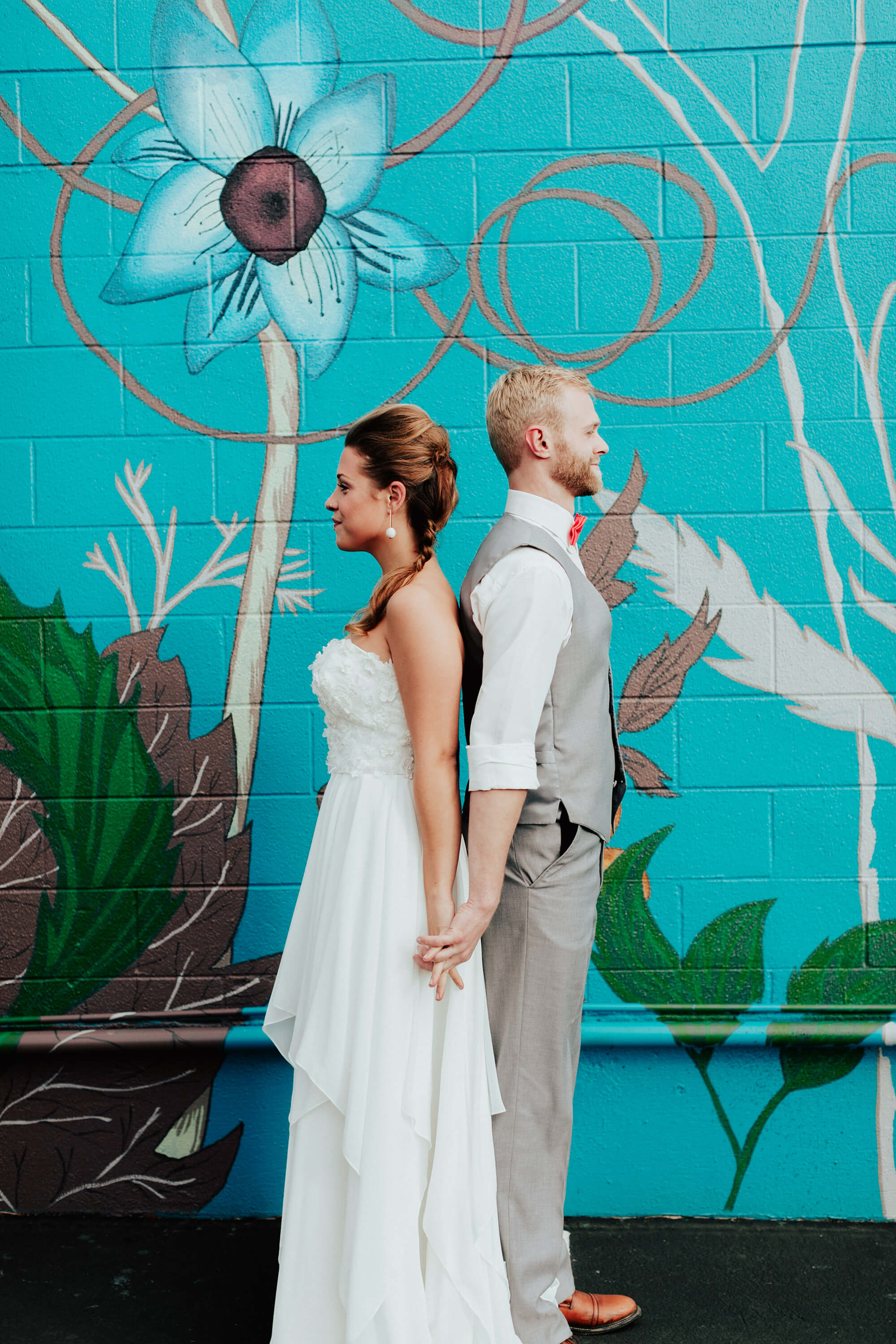 bride and groom portrait by mural
