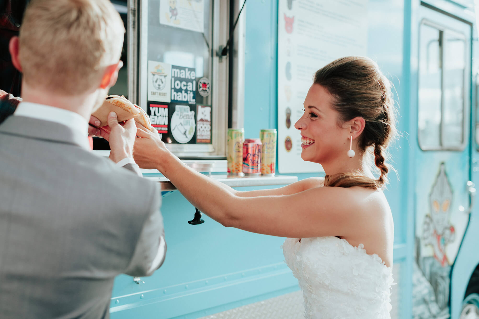 bride and groom getting food from food truck