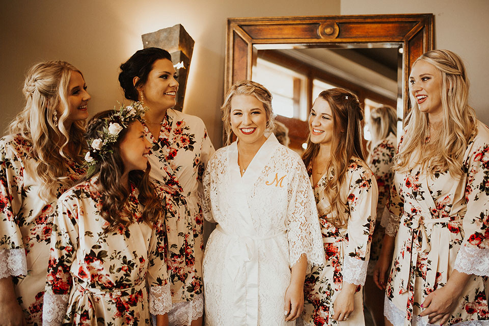 bride with bridal party getting ready in floral robes