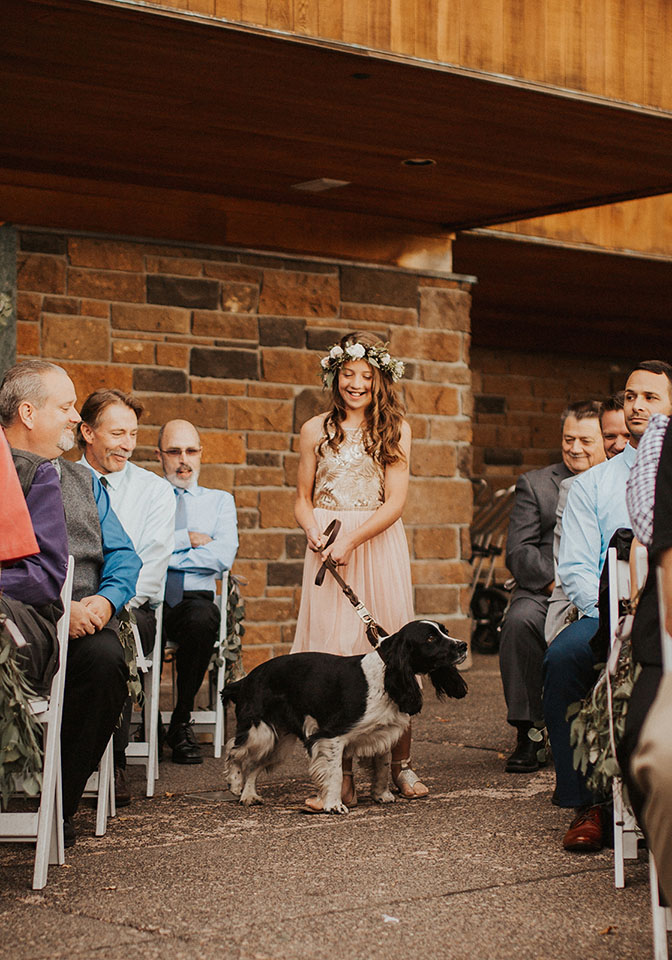 flower girl and dog walking down aisle