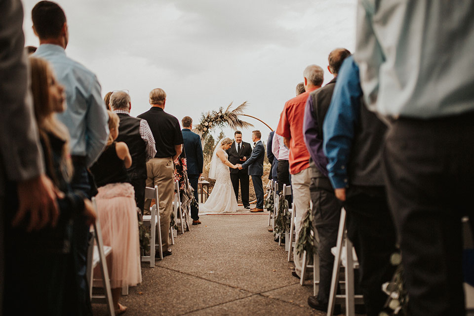 ceremony with copper circle arch backdrop