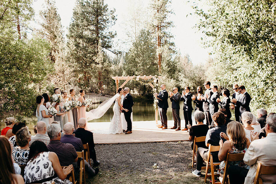 first kiss bride and groom outdoor ceremony