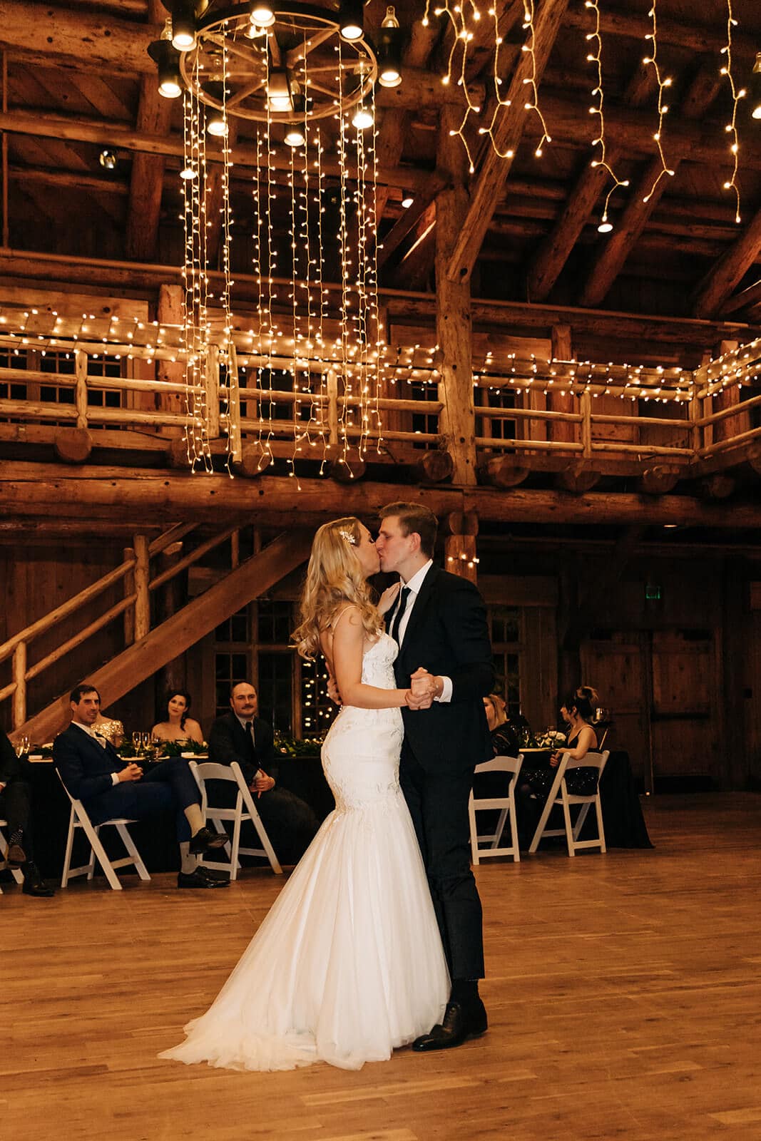 bride and groom kissing under lighting