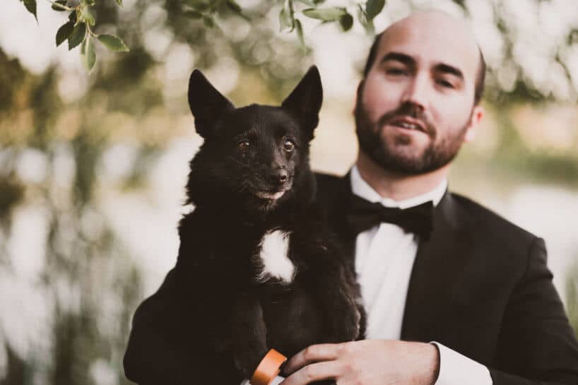 Groom with his cute black little dog