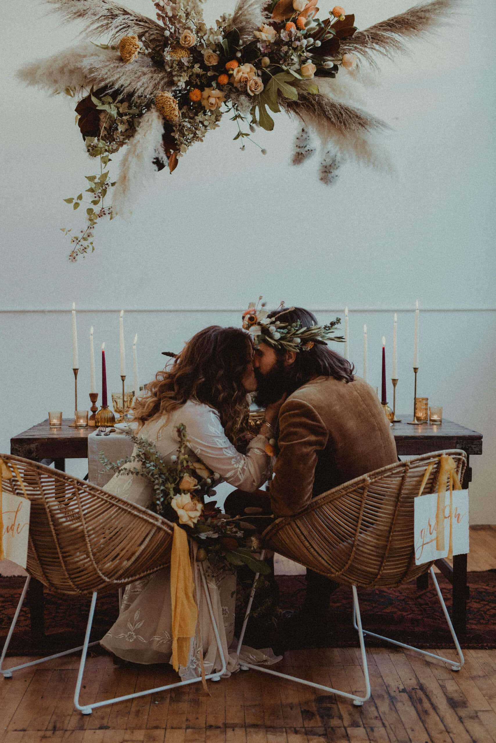 bride and groom sitting at sweetheart table