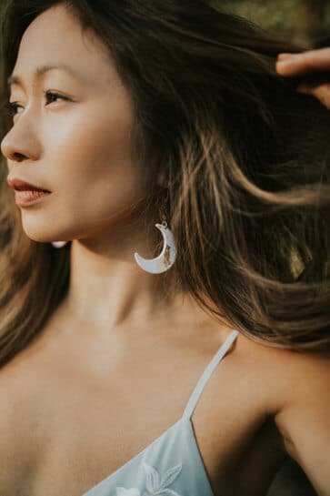 women wearing moon shaped earrings