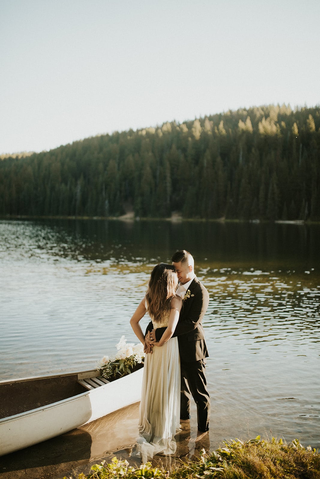 Couple standing in lake kissing