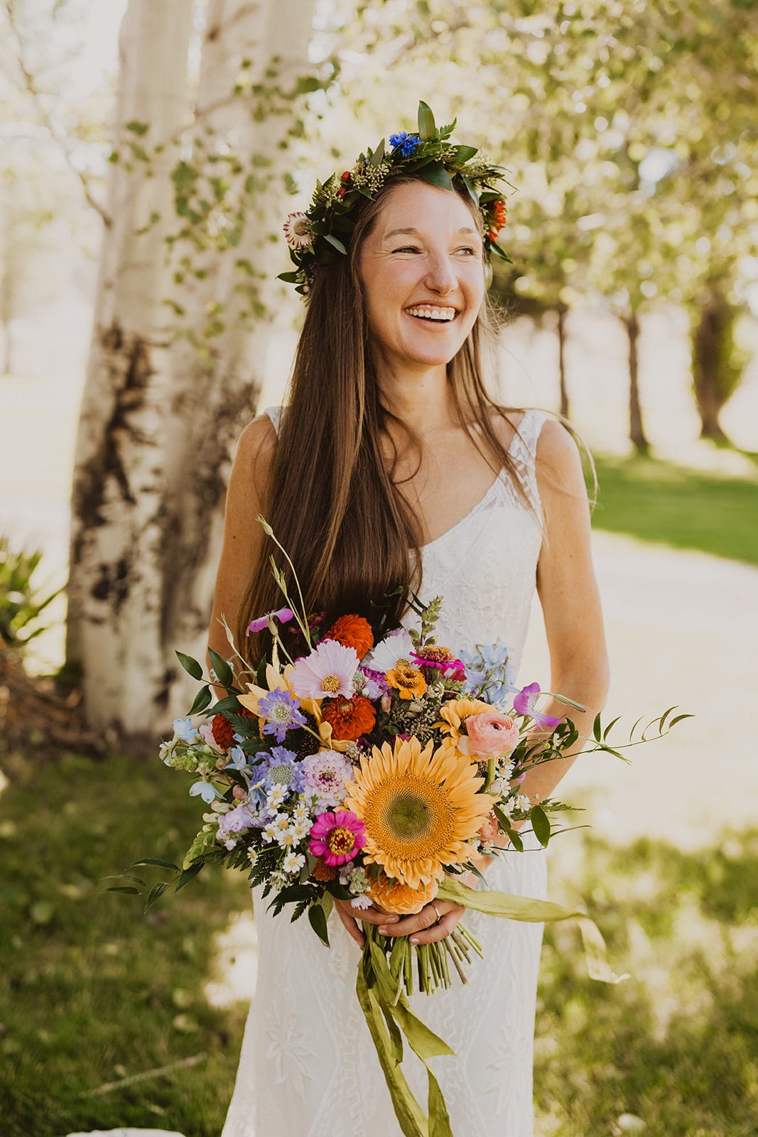 bride holding her colorful florals