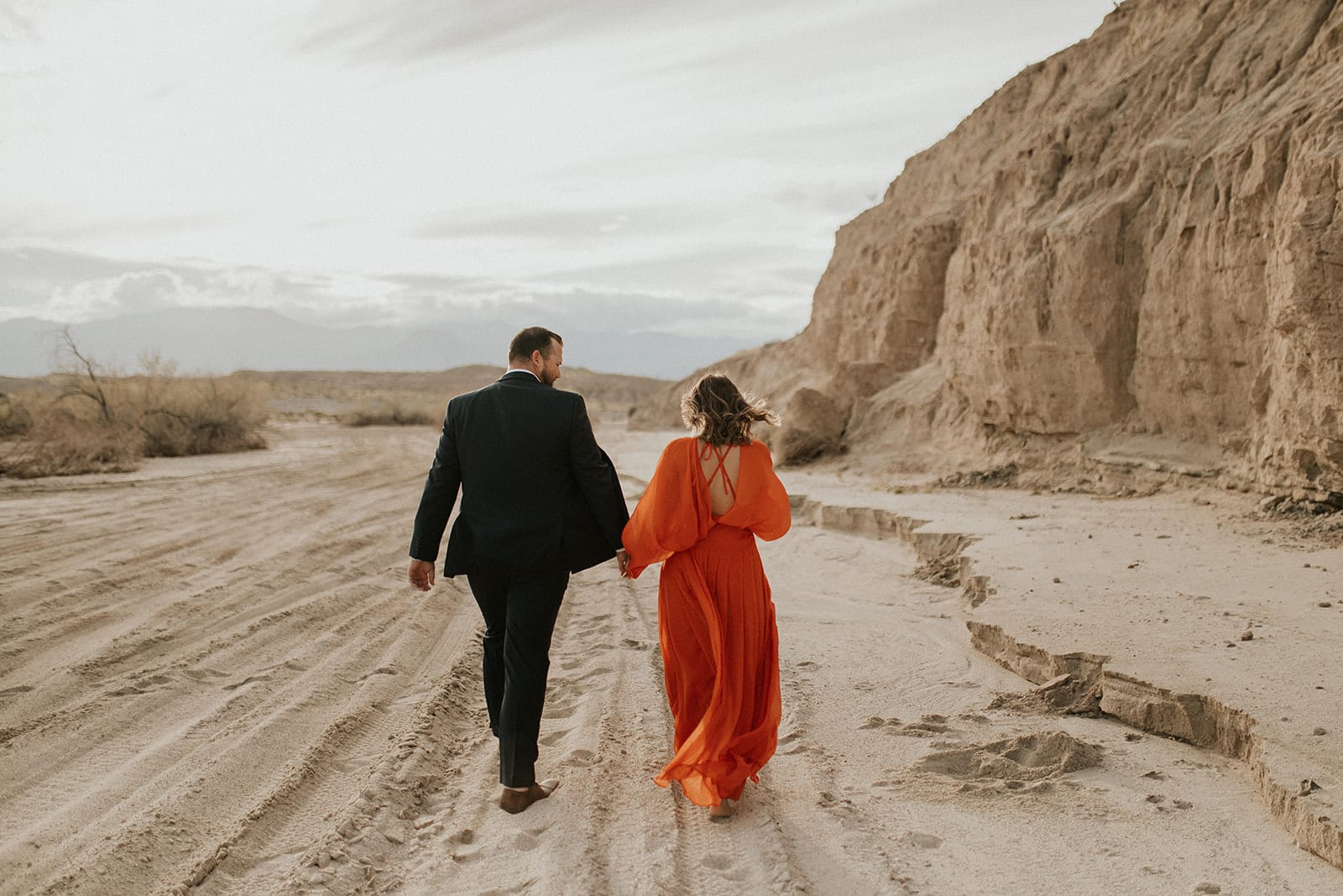 man and woman through desert