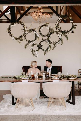 green white flower rings over wedding table